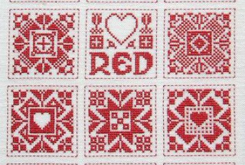 Red and white cross stitch sampler